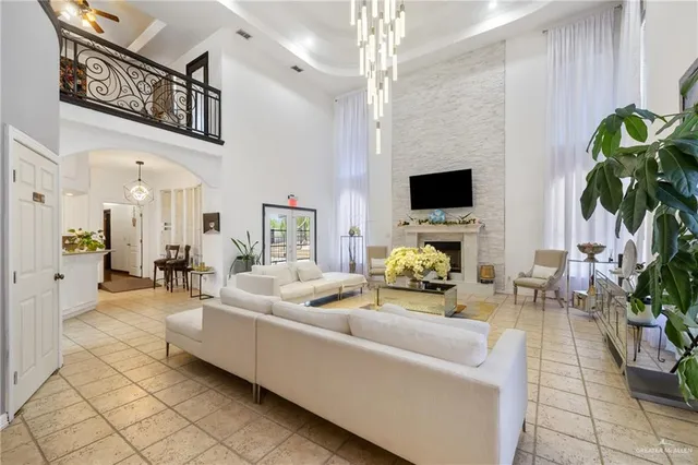 a living room with furniture a fireplace and a potted plant