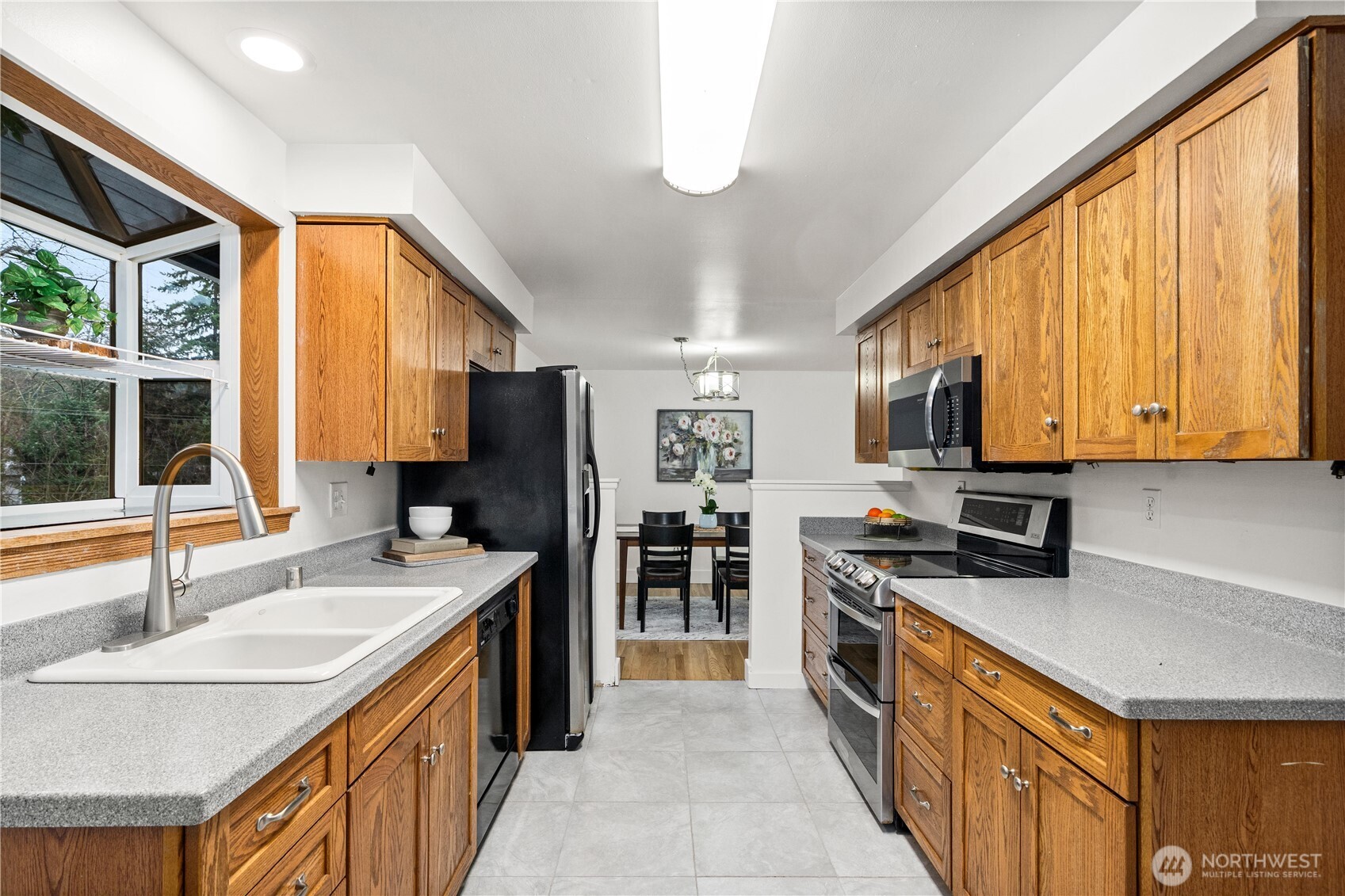 114 Southwest 313th Street Federal Way, WA 98023 - Photo 11 of 40 a kitchen with stainless steel appliances granite countertop a sink stove and cabinets