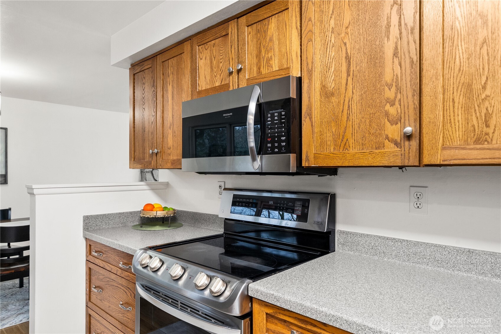 114 Southwest 313th Street Federal Way, WA 98023 - Photo 12 of 40 a kitchen with stainless steel appliances a stove a microwave and cabinets