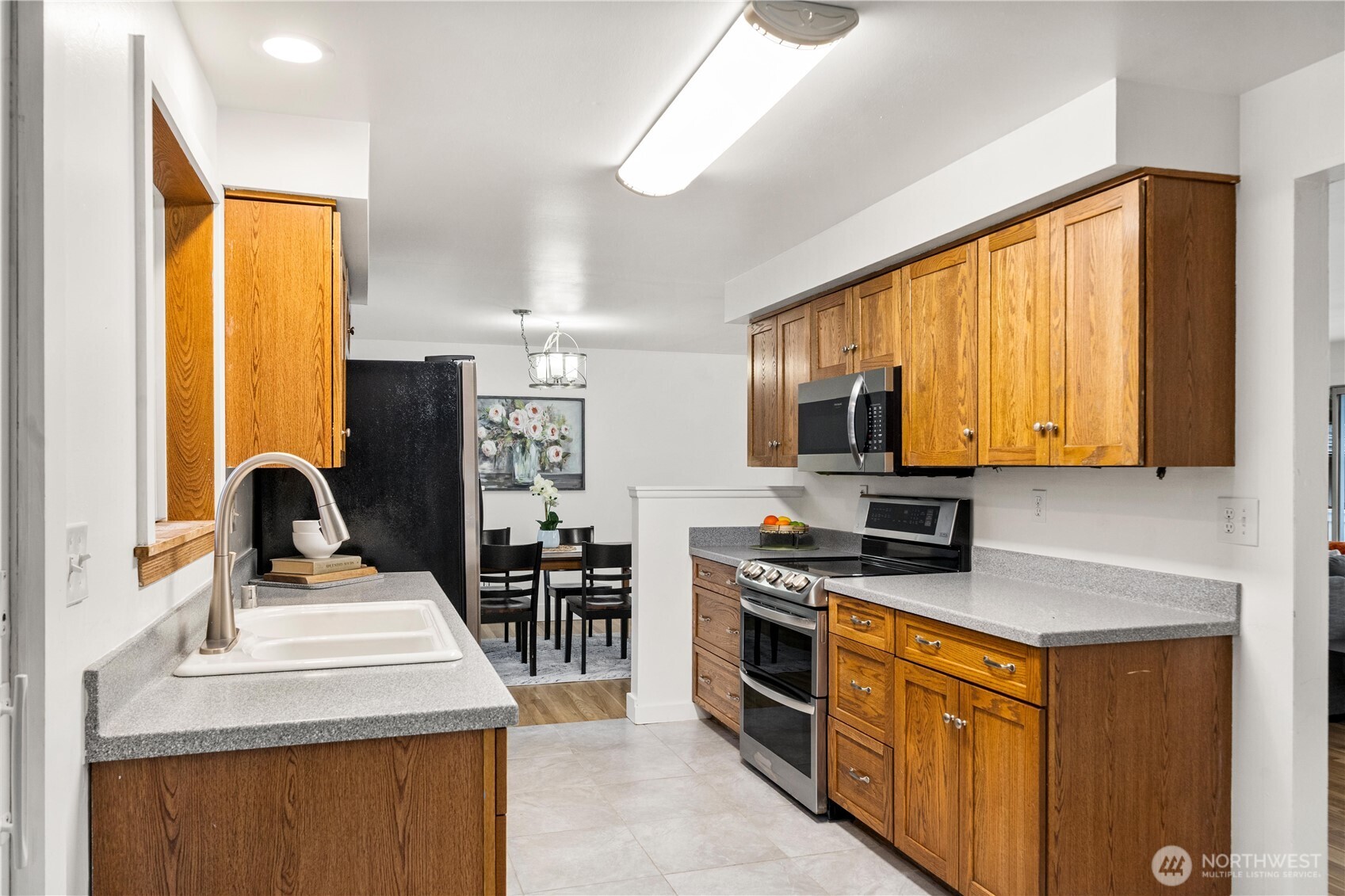 114 Southwest 313th Street Federal Way, WA 98023 - Photo 14 of 40 a kitchen with stainless steel appliances a stove sink and refrigerator