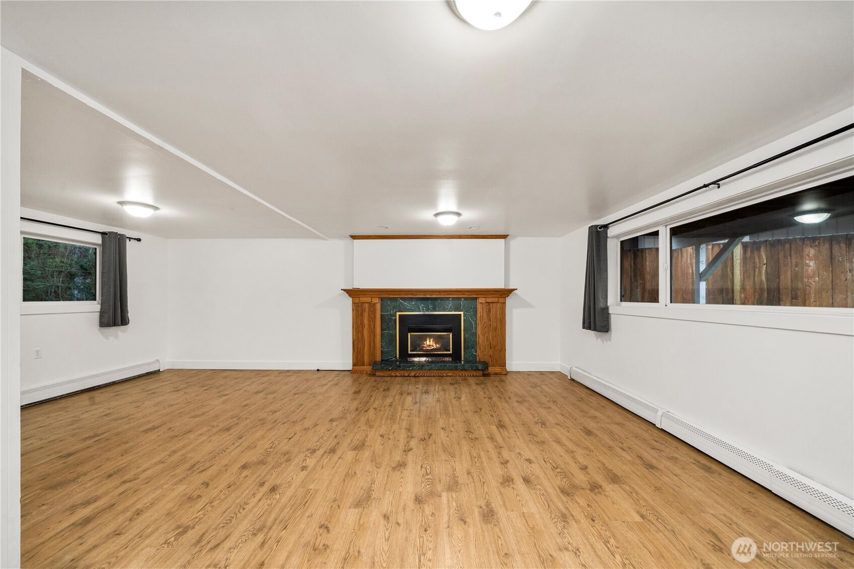 114 Southwest 313th Street Federal Way, WA 98023 - Photo 23 of 40 a view of an empty room with wooden floor fireplace and a window