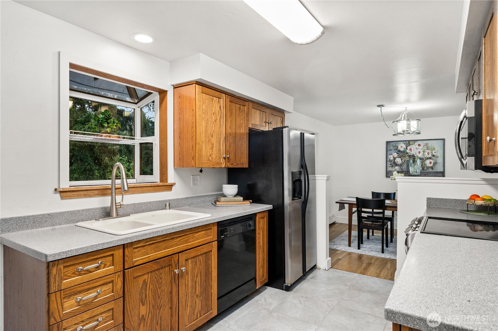 114 Southwest 313th Street Federal Way, WA 98023 - Photo 10 of 40 a kitchen with stainless steel appliances a sink stove and a refrigerator