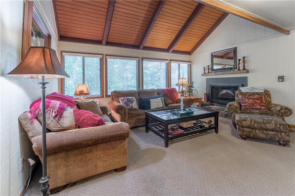135 Wolfscratch Drive Jasper, GA 30143 - Photo 7 of 18 a living room with furniture a fireplace and a large window
