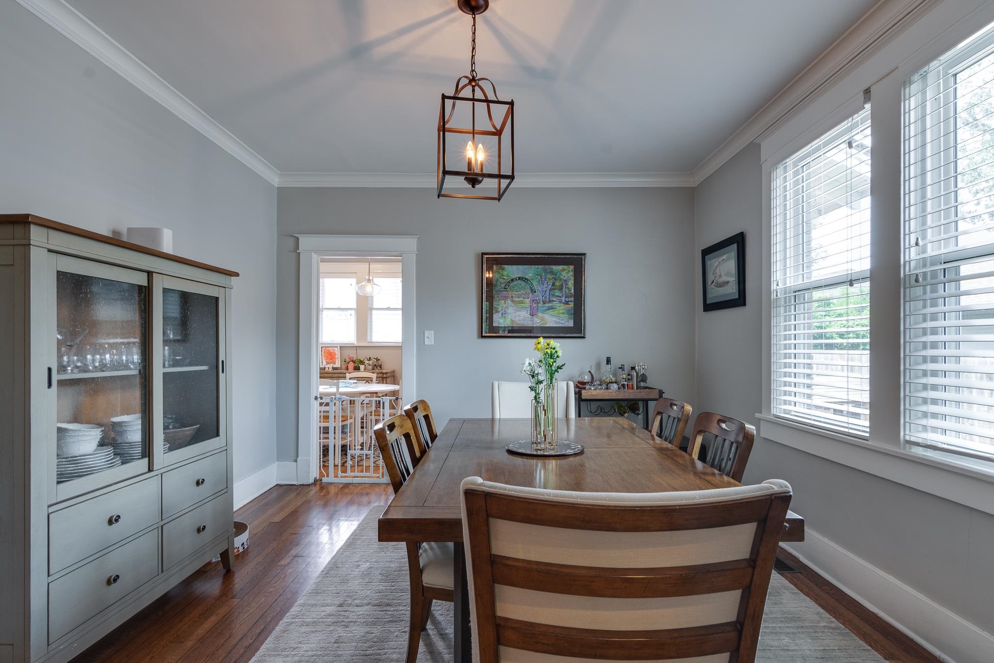 279 Angelus Street Memphis, TN 38112 - Photo 11 of 34 a dining room with wooden floor a chandelier a wooden table and chairs