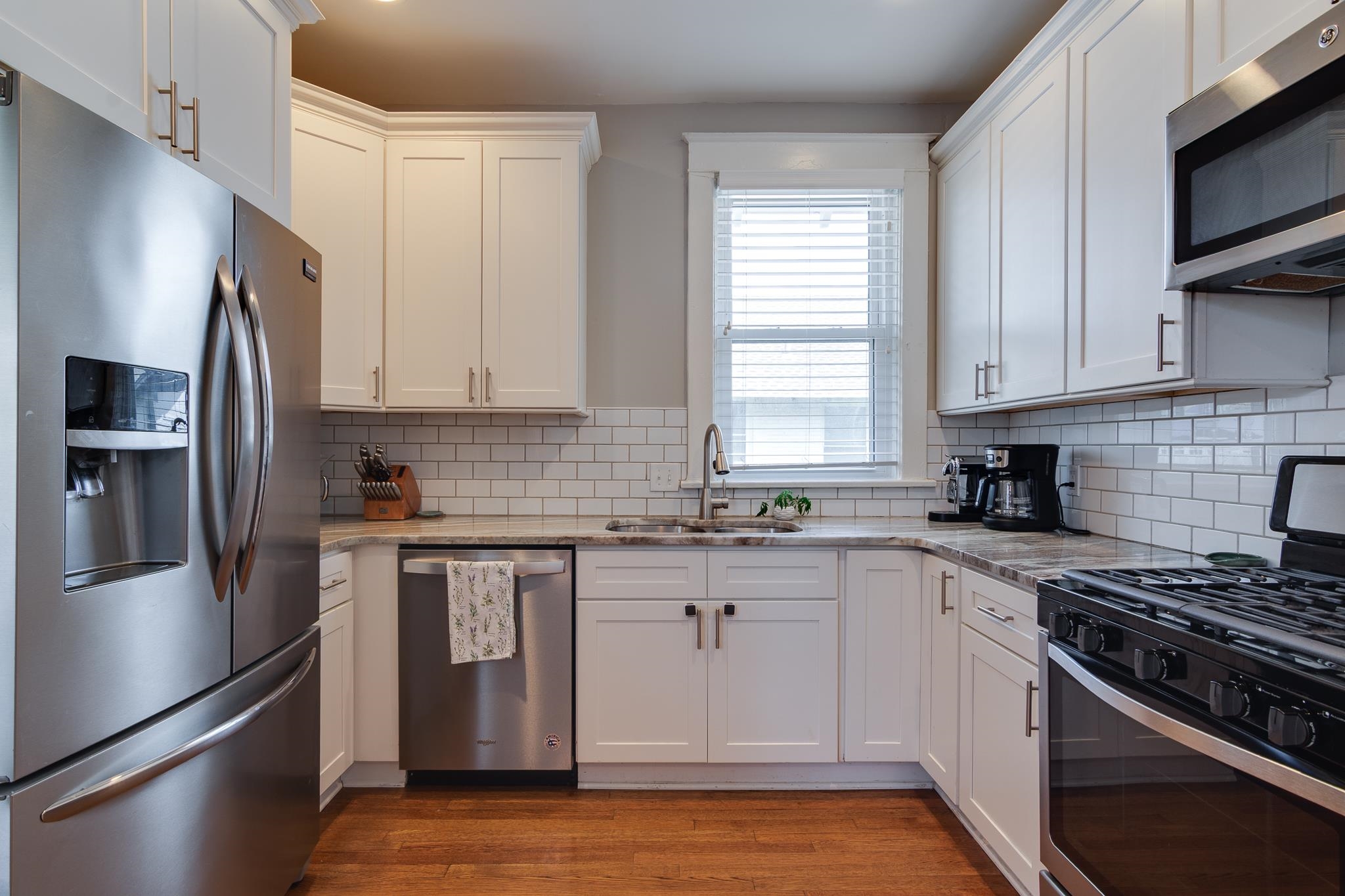 279 Angelus Street Memphis, TN 38112 - Photo 16 of 34 a kitchen with stainless steel appliances granite countertop a stove a sink and a refrigerator