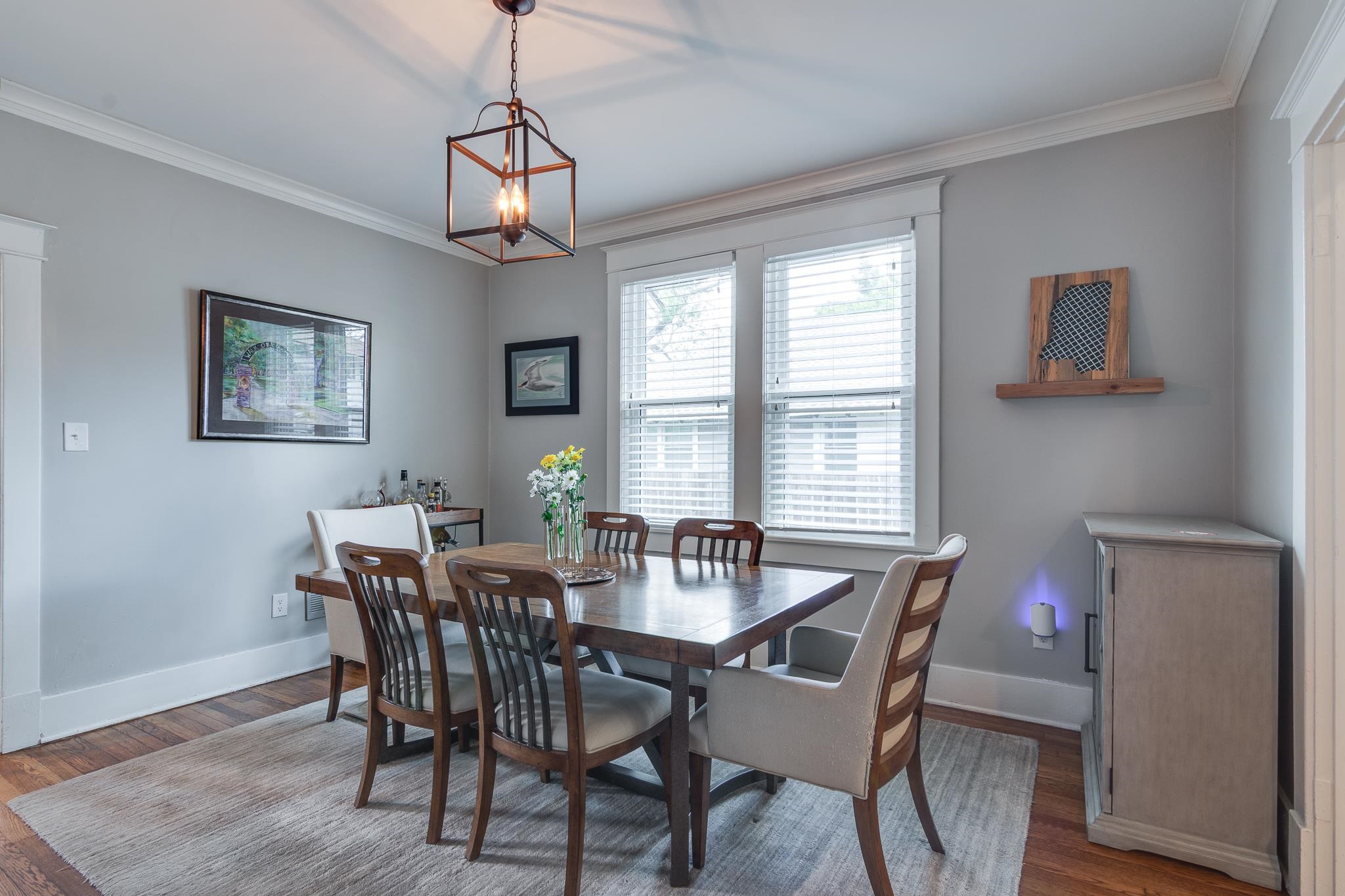 279 Angelus Street Memphis, TN 38112 - Photo 9 of 34 a dining room with furniture a chandelier and wooden floor