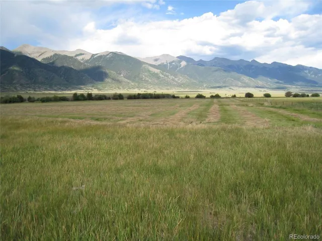 a view of a town with mountains in the background