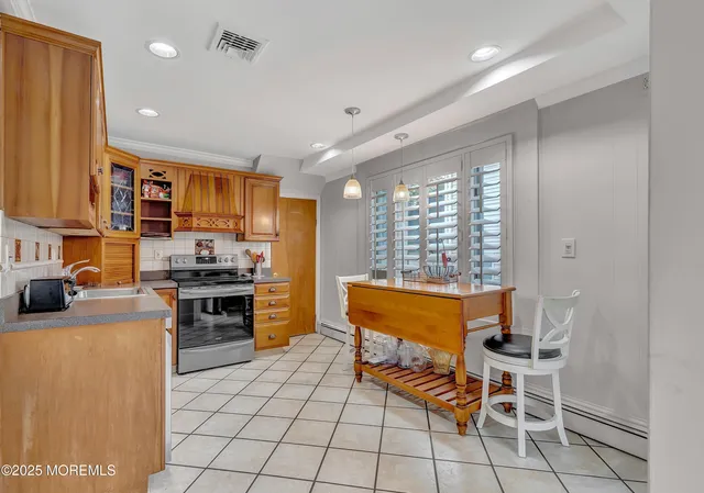 a kitchen with stainless steel appliances kitchen island granite countertop a sink and cabinets