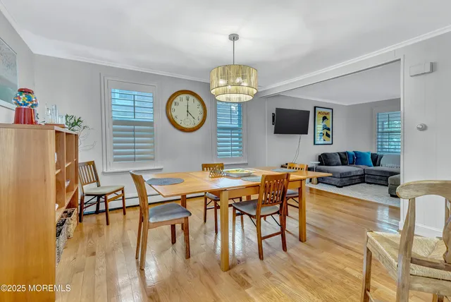 a view of a dining room with furniture wooden floor and chandelier