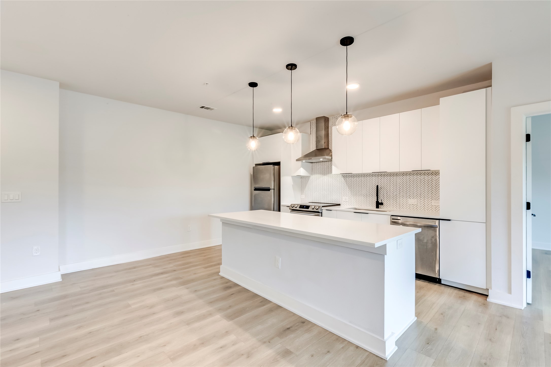 2500 Longview Street, Unit 402 Austin, TX 78705 - Photo 8 of 27 a kitchen with kitchen island a sink stainless steel appliances and cabinets