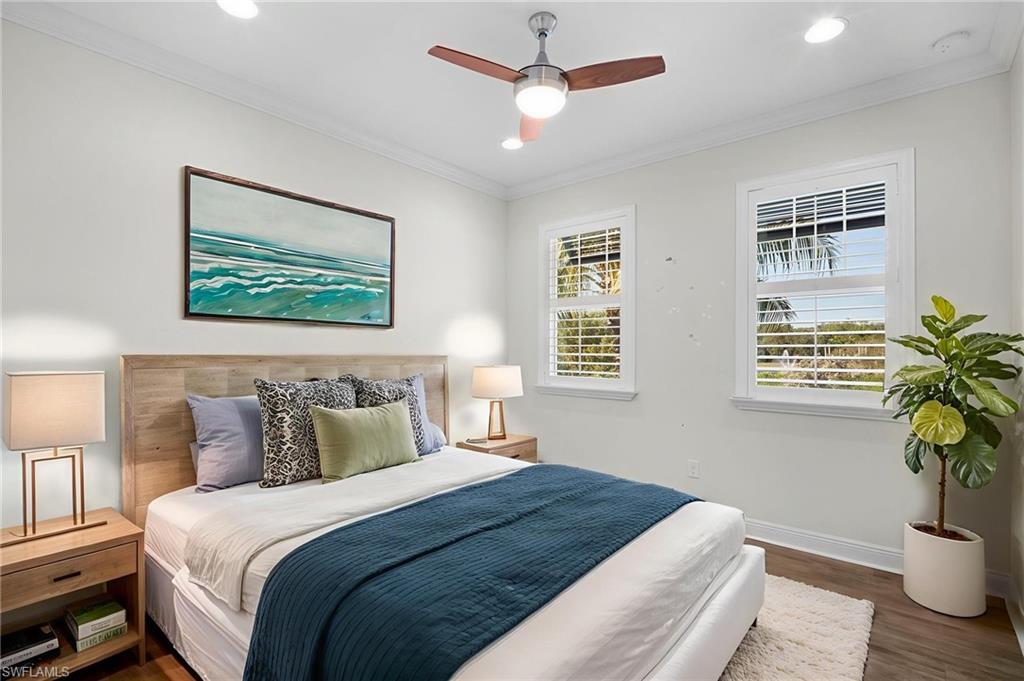 6934 Avalon Circle, Unit 405 Naples, FL 34112 - Photo 6 of 16 Bedroom with dark wood-type flooring, a ceiling fan, ornamental molding, and recessed lighting