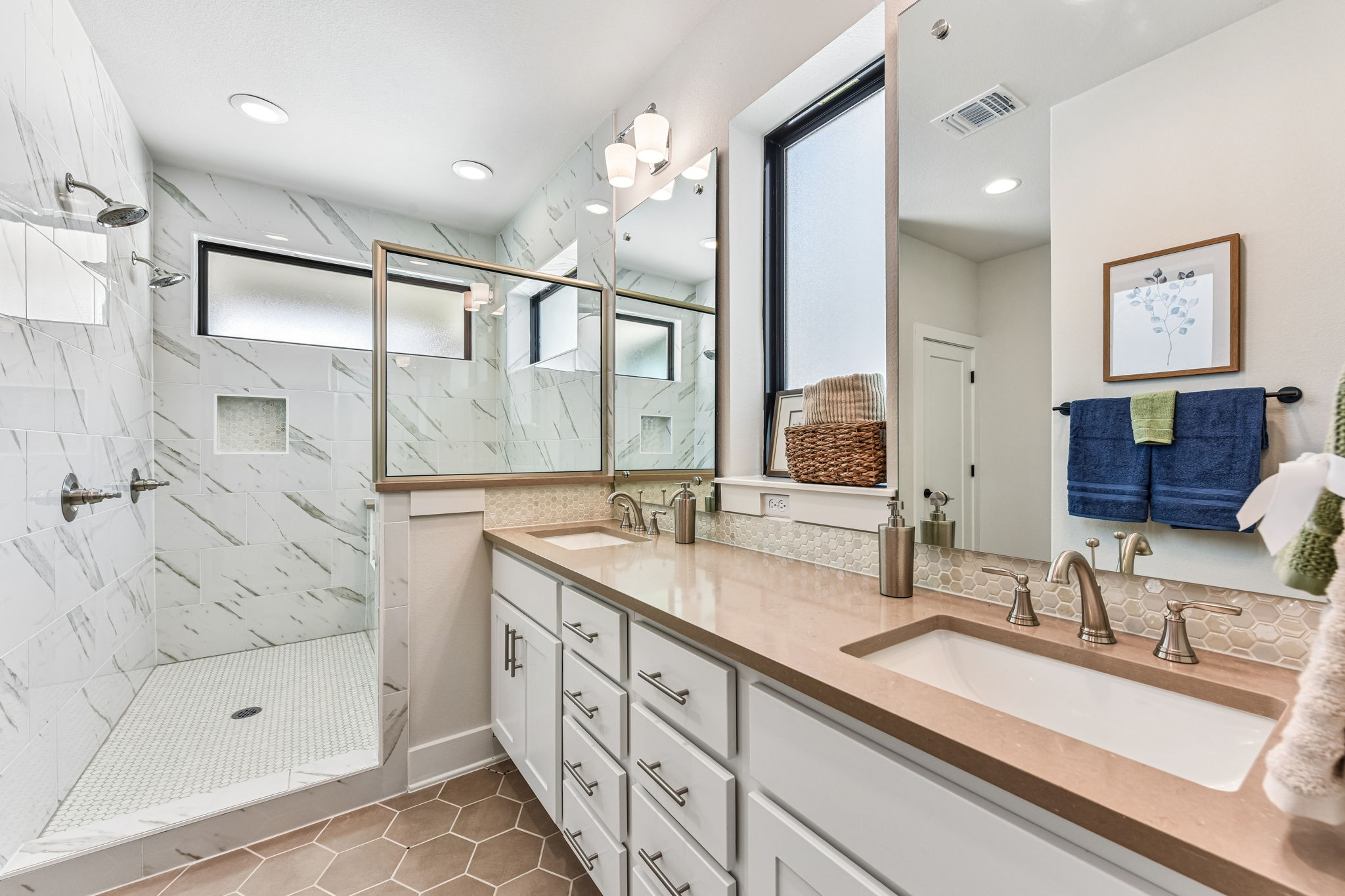 9033 Cattle Baron Path Austin, TX 78747 - Photo 32 of 40 Dual vanities and a spacious glass-enclosed shower create a rejuvenating primary bathroom retreat.