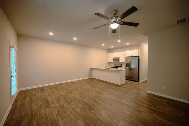 a view of a kitchen with a sink and a refrigerator