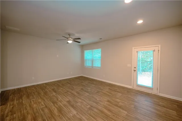 wooden floor in an empty room with a window