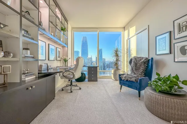 a bedroom with furniture and a large window