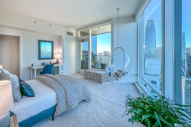 a spacious bathroom with a bathtub and potted plant