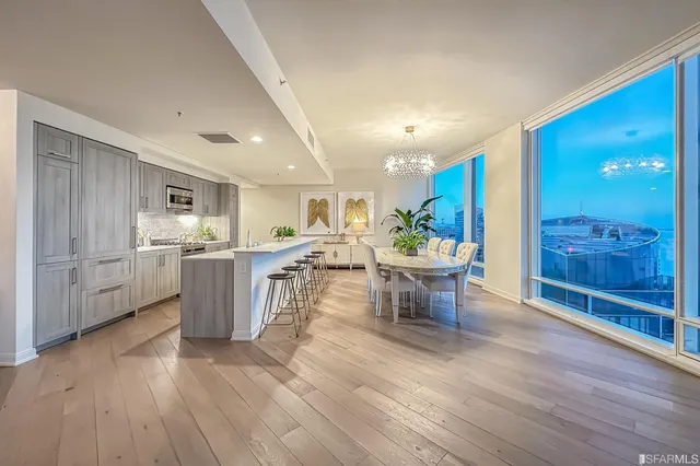 a view of a dining room with furniture and chandelier