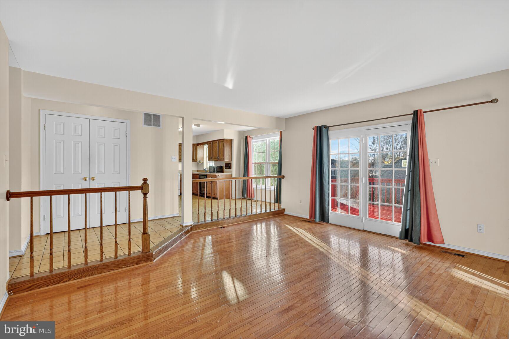 12416 Loft Lane Silver Spring, MD 20904 - Photo 13 of 25 a view of a big room with wooden floor and windows