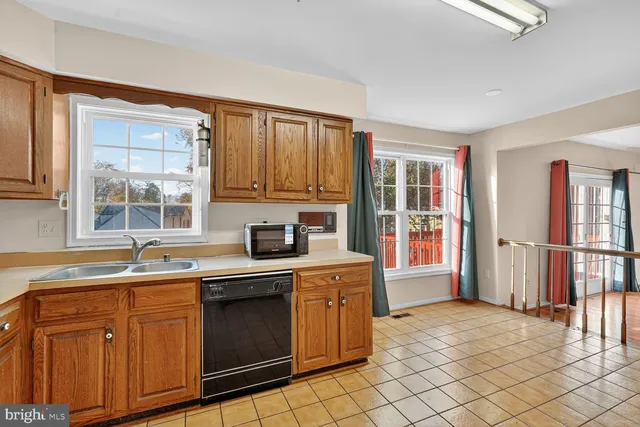 a kitchen with stainless steel appliances granite countertop a stove top oven a sink a counter space and cabinets