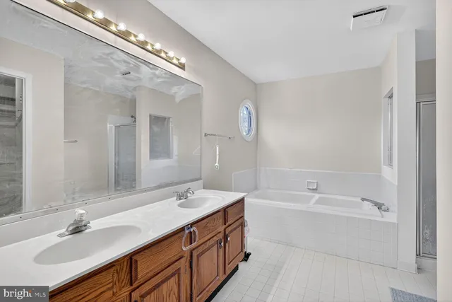 a bathroom with a bathtub and a shower