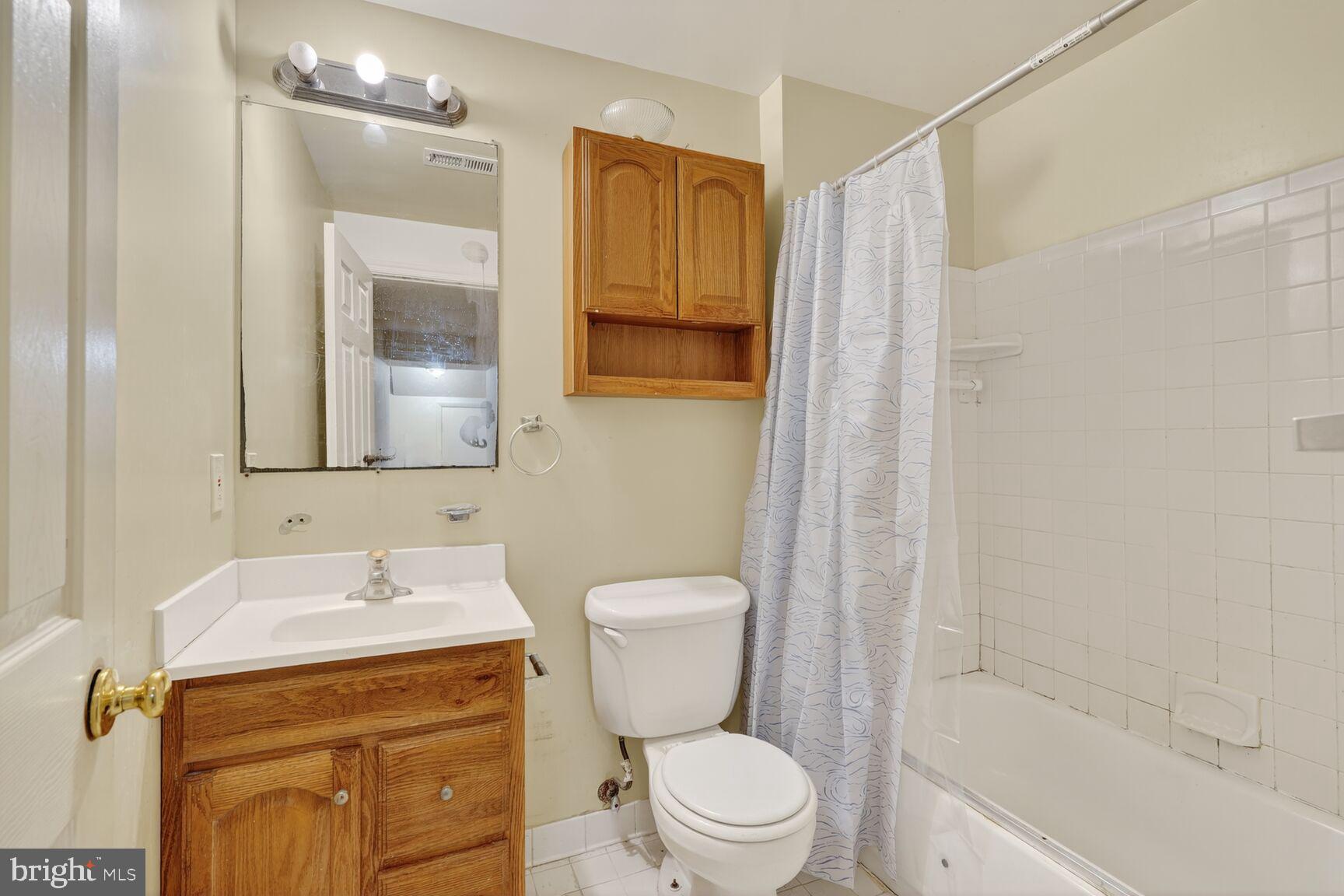 12416 Loft Lane Silver Spring, MD 20904 - Photo 24 of 25 a bathroom with a sink a toilet and shower