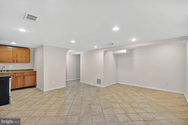 a view of kitchen with stainless steel appliances a refrigerator and a stove top oven