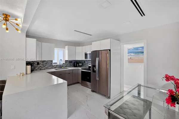 a kitchen with stainless steel appliances a refrigerator sink and cabinets