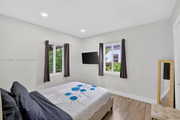 a bedroom with a bed and a window