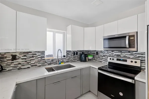 a kitchen with a sink stove and microwave