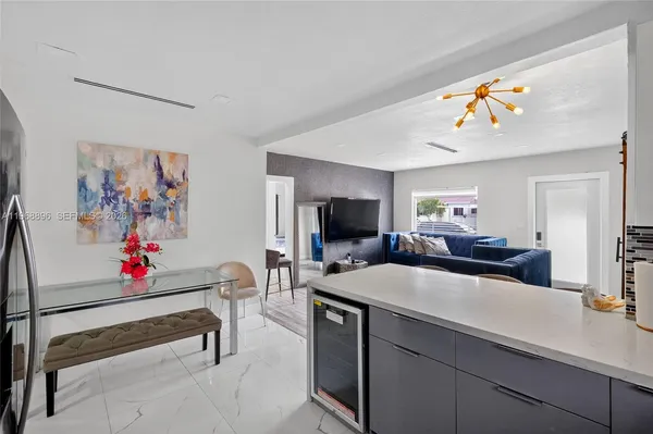 a living room with kitchen island furniture and a flat screen tv