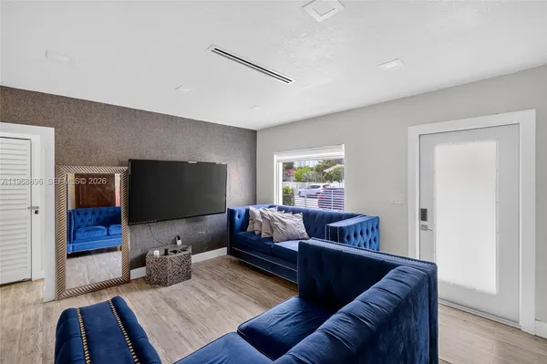 a living room with furniture and a flat screen tv