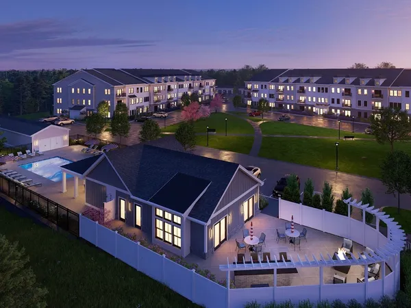 an aerial view of residential houses with outdoor space and city view