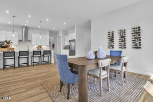 1127 Masters Place Way, Unit 164 Durham, NC 27703 - Photo 12 of 45 a dining room with furniture and wooden floor