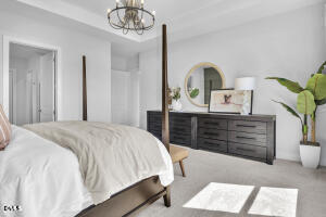 1127 Masters Place Way, Unit 164 Durham, NC 27703 - Photo 17 of 45 a bedroom with a bed and a chandelier