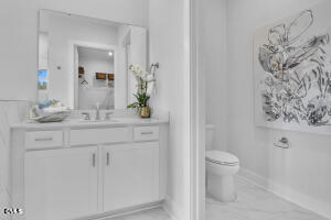1127 Masters Place Way, Unit 164 Durham, NC 27703 - Photo 21 of 45 a bathroom with a granite countertop sink a toilet and a mirror