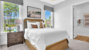 1127 Masters Place Way, Unit 164 Durham, NC 27703 - Photo 25 of 45 a bedroom with a bed and a painting on the wall