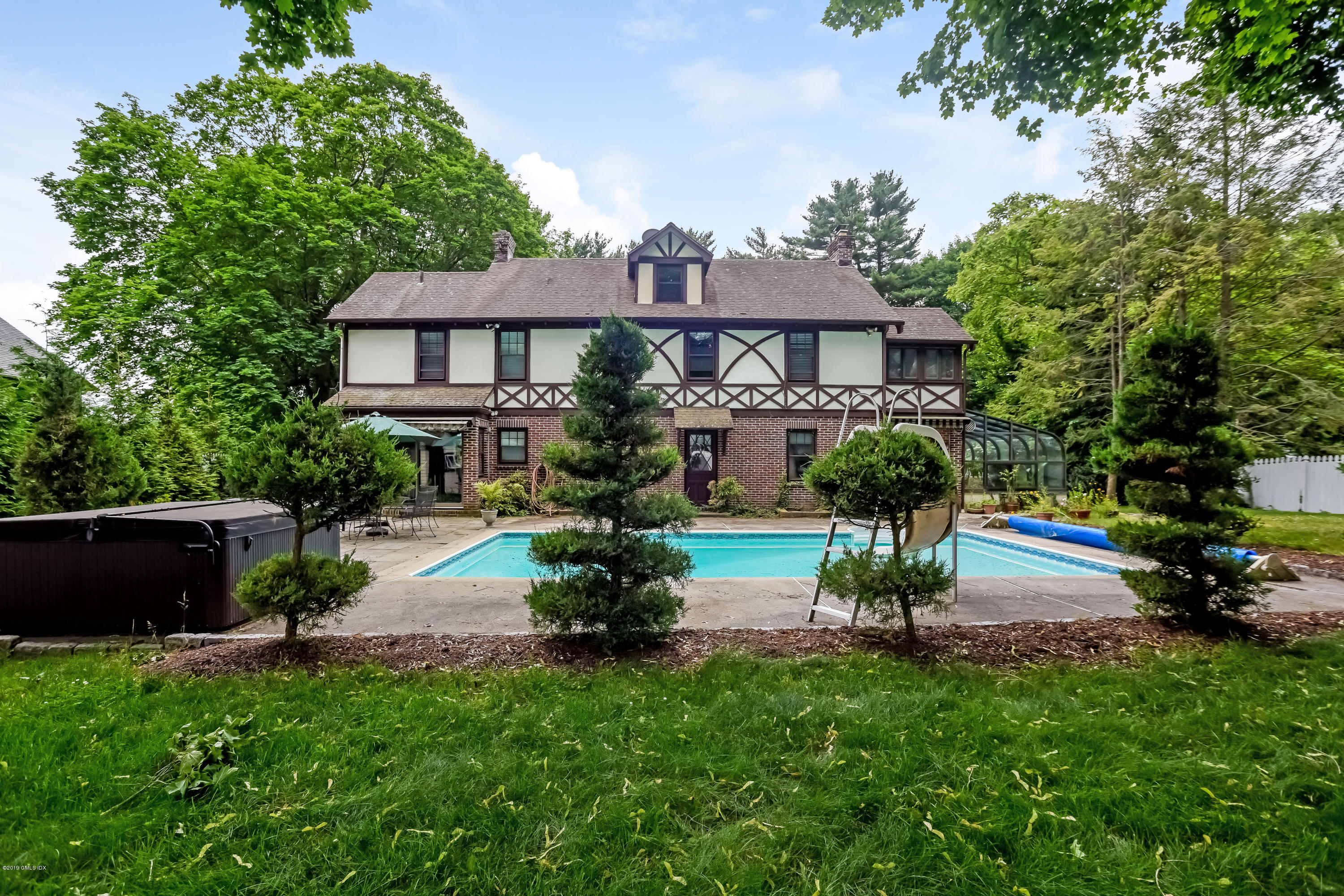 a view of a house with a yard and a patio