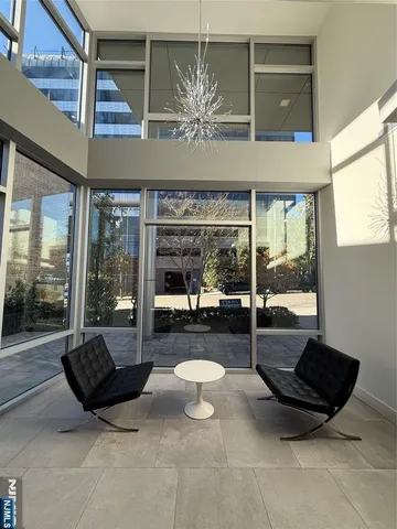 a living room with furniture and a floor to ceiling window