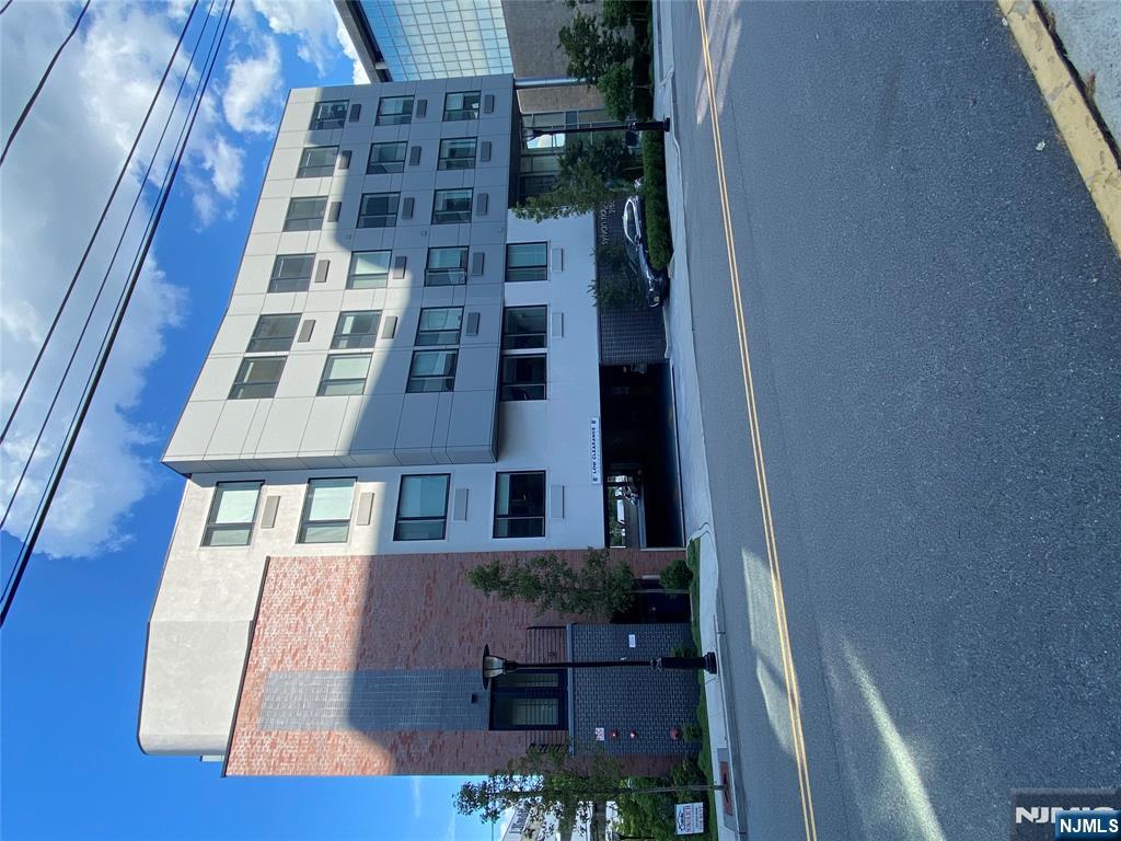 2150 North Central Road, Unit 410 Fort Lee, NJ 07024 - Photo 2 of 15 a tall building with a street