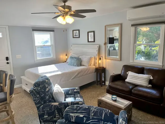 a bedroom with a bed gym equipment and a window