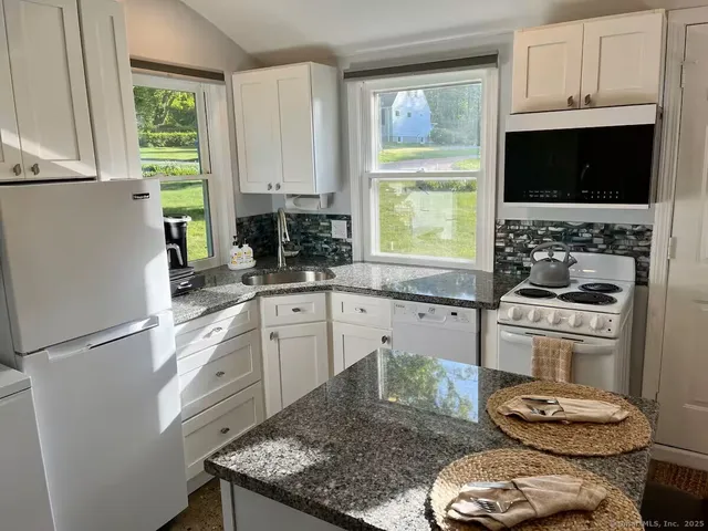 a kitchen with a stove a sink and a microwave