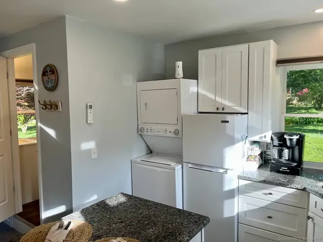 a kitchen with stainless steel appliances a refrigerator sink and cabinets