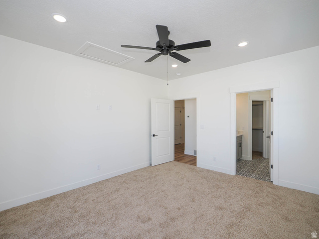 3938 North Wood Road Eagle Mountain, UT 84005 - Photo 18 of 55 Unfurnished bedroom featuring carpet floors, a ceiling fan, recessed lighting, and ensuite bath