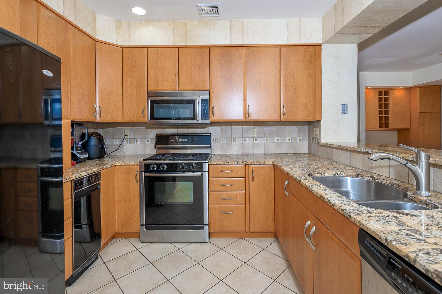 28 Stonebridge Lane Princeton, NJ 08540 - Photo 12 of 34 a kitchen with granite countertop a sink stainless steel appliances and cabinets
