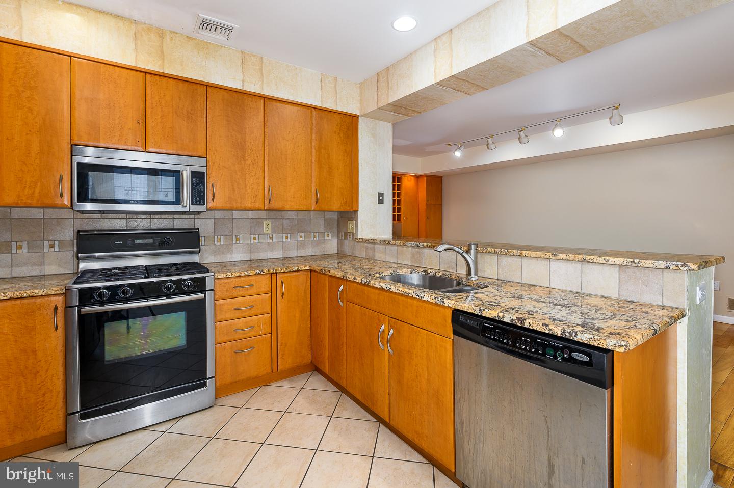 28 Stonebridge Lane Princeton, NJ 08540 - Photo 13 of 34 a kitchen with stainless steel appliances granite countertop a sink stove and microwave