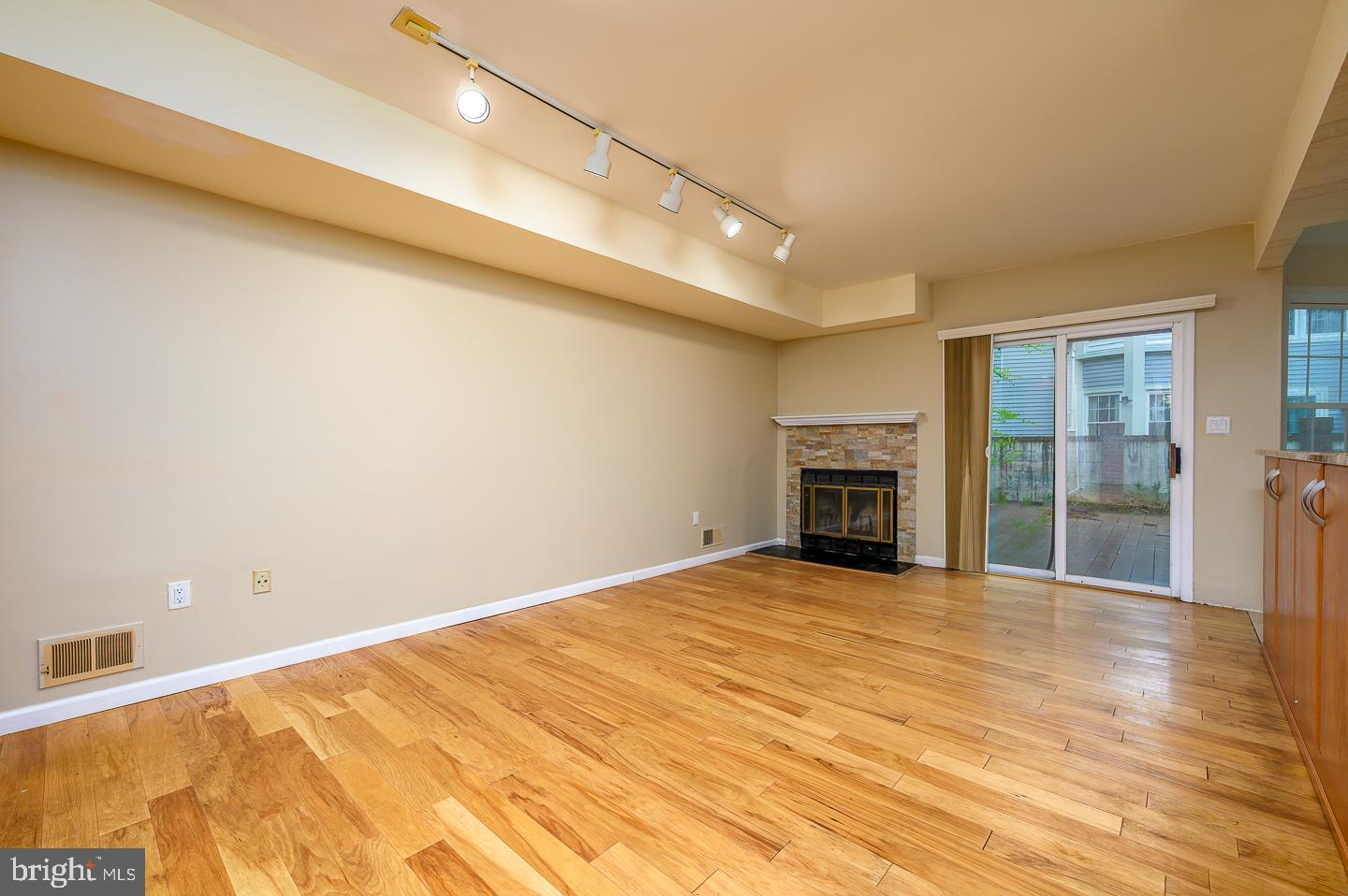 28 Stonebridge Lane Princeton, NJ 08540 - Photo 19 of 34 a view of an empty room with wooden floor and a fireplace
