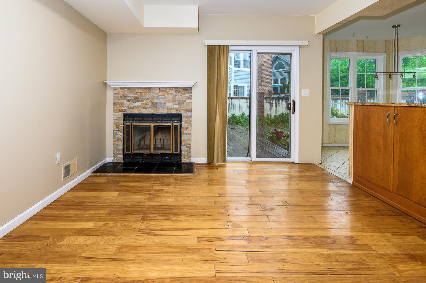 28 Stonebridge Lane Princeton, NJ 08540 - Photo 20 of 34 a view of an empty room with wooden floor and a fireplace