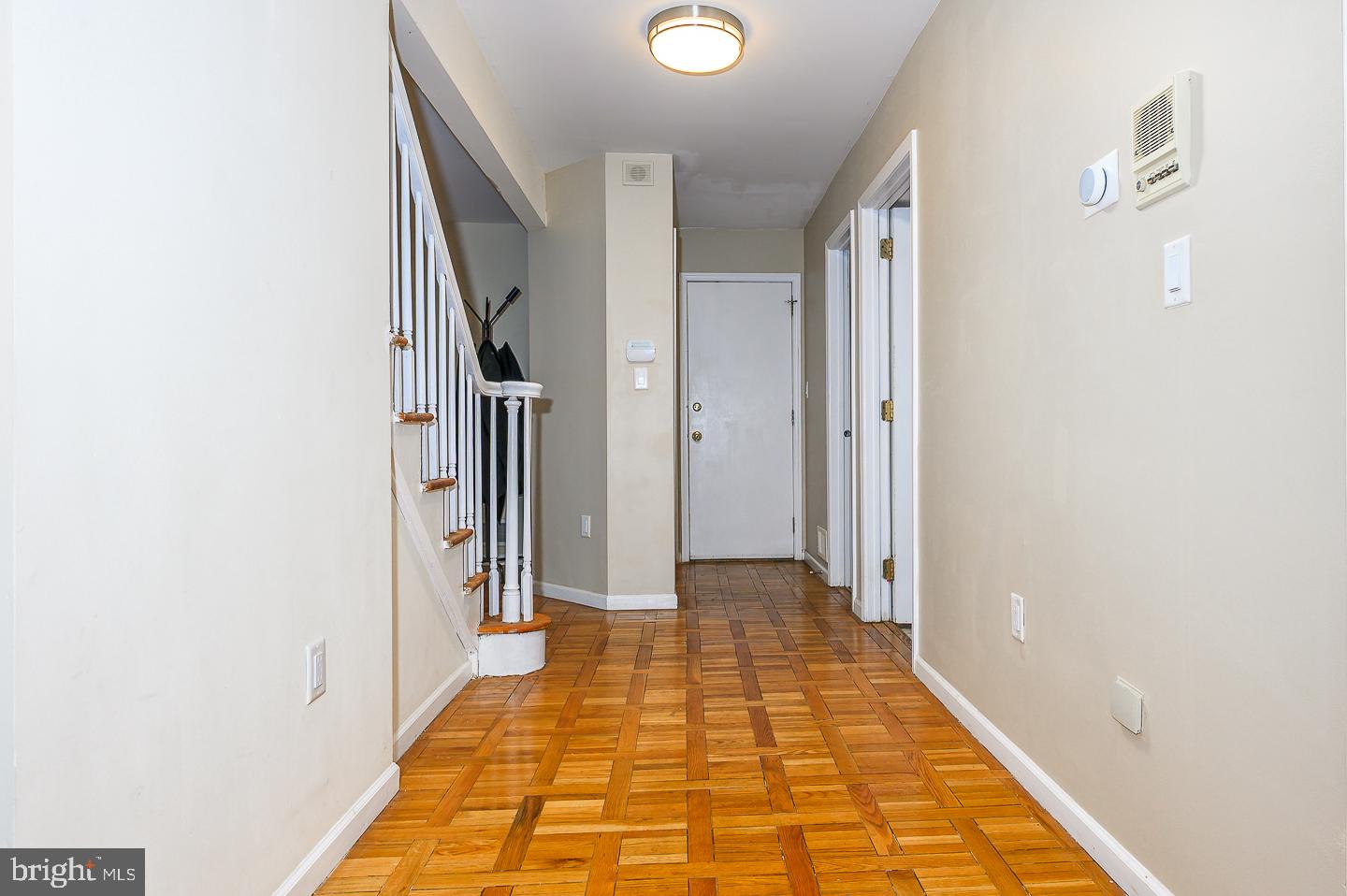 28 Stonebridge Lane Princeton, NJ 08540 - Photo 21 of 34 a view of a hallway with wooden floor and staircase