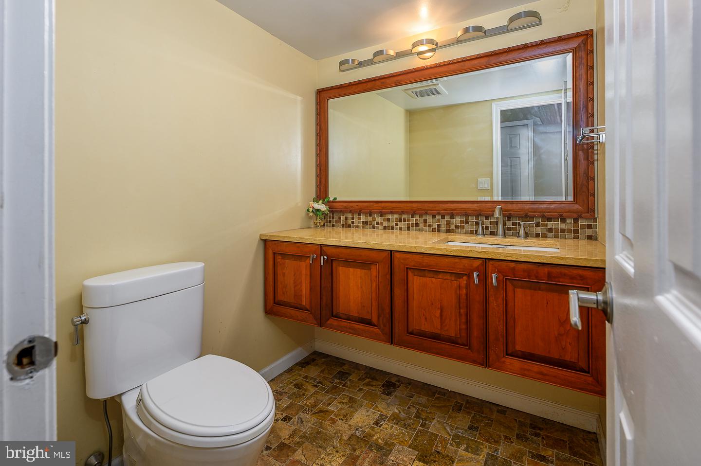 28 Stonebridge Lane Princeton, NJ 08540 - Photo 22 of 34 a bathroom with a toilet a sink and mirror