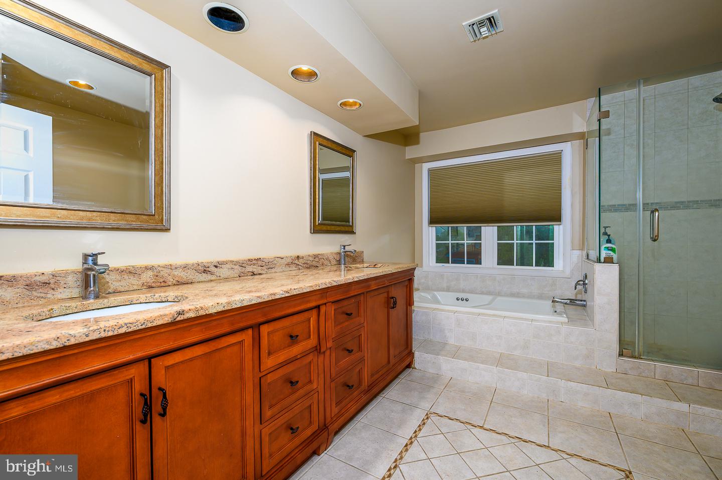 28 Stonebridge Lane Princeton, NJ 08540 - Photo 26 of 34 a spacious bathroom with a granite countertop sink and a large mirror
